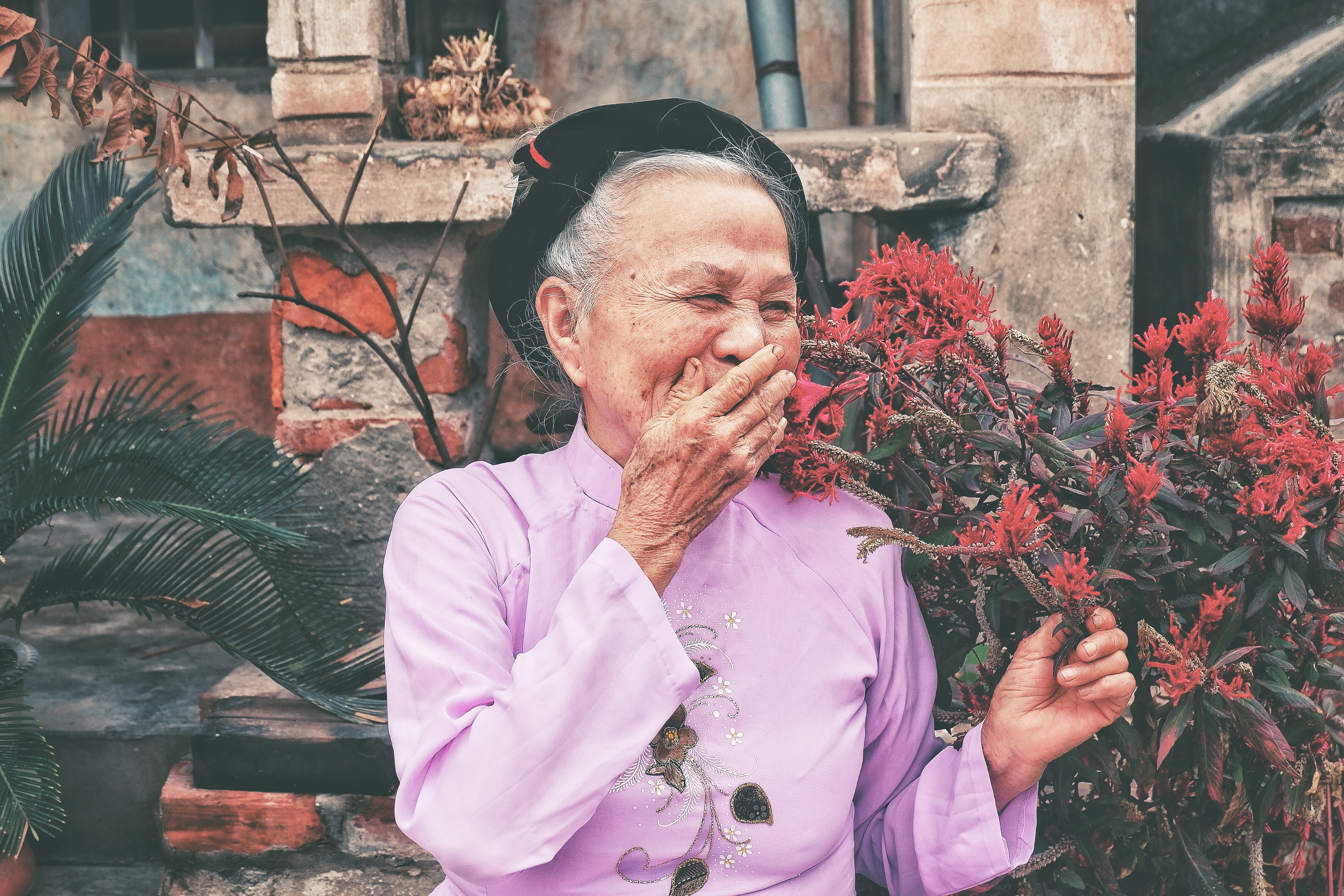 old lady standing amongst plants