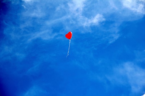 Floating heart in a blue sky