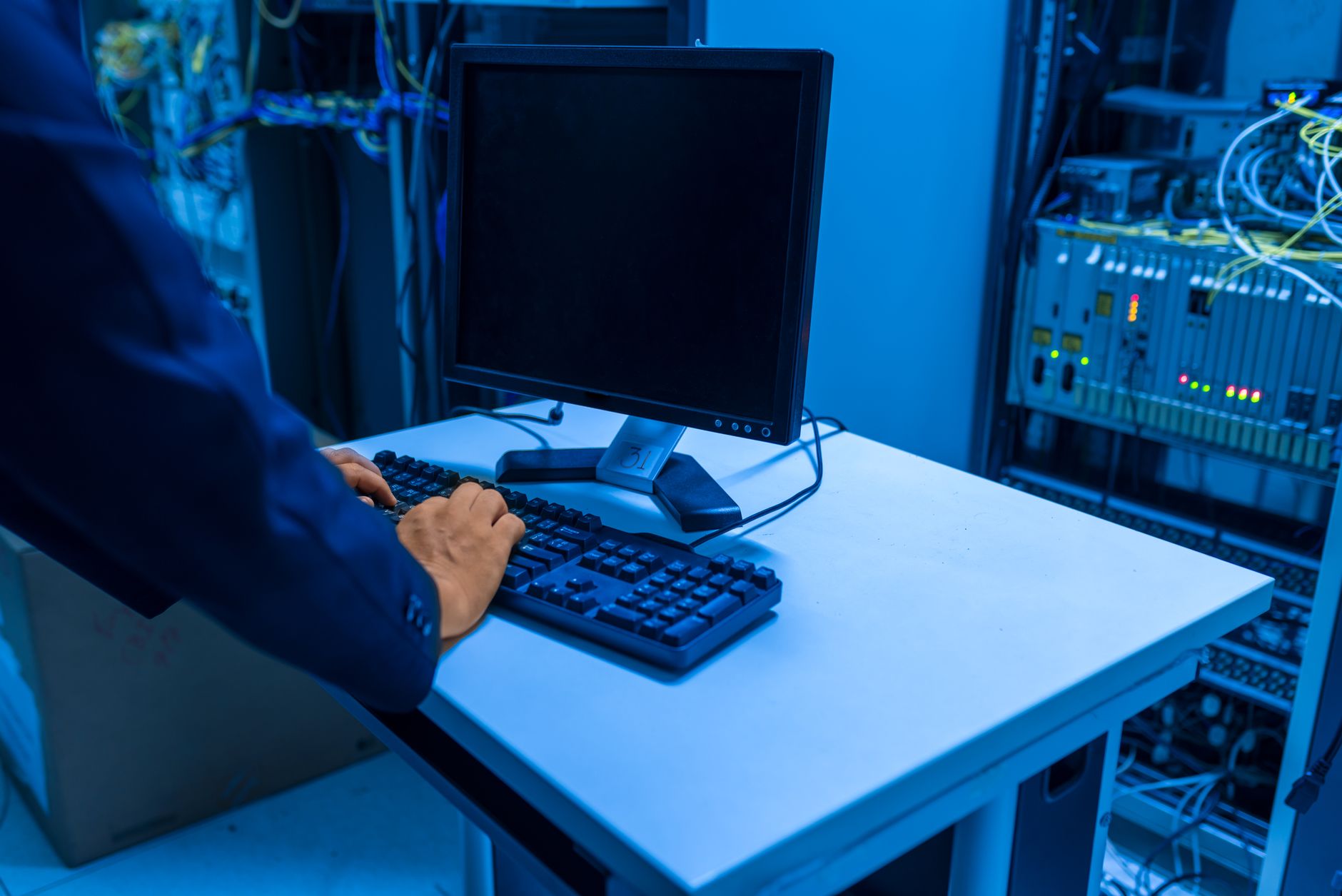 IT technician monitoring systems in a server room