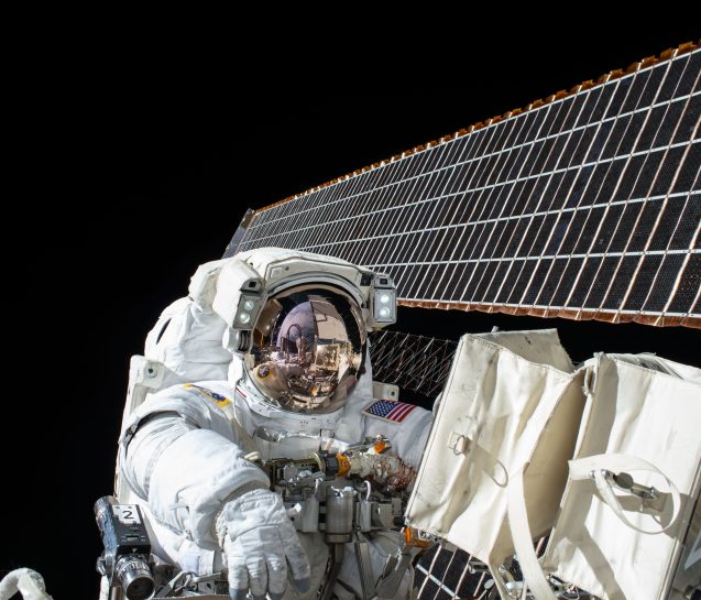 astronaut in space configuring equipment