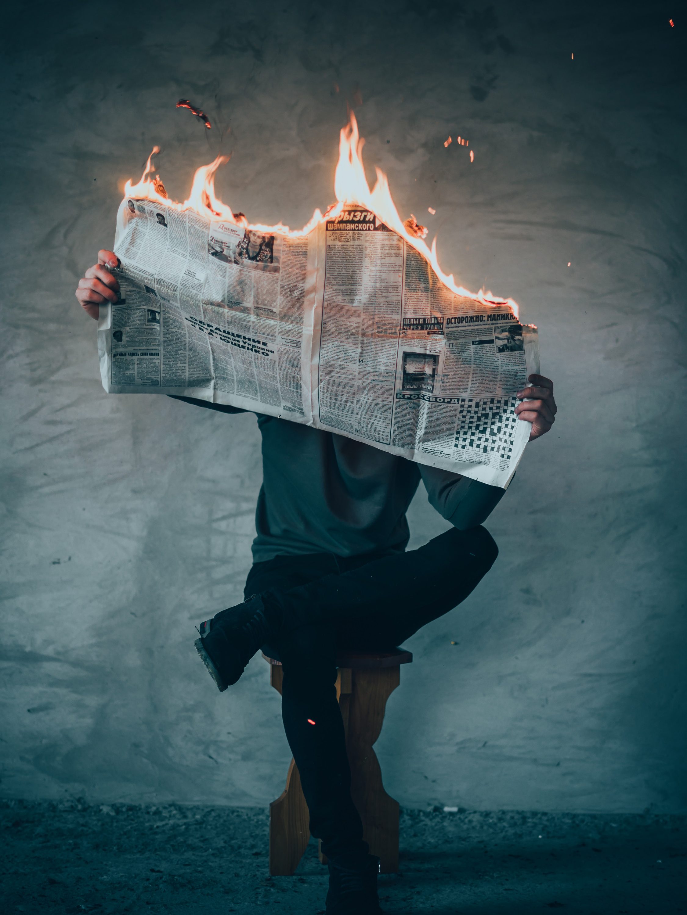 social media savvy man burning an outdated news paper