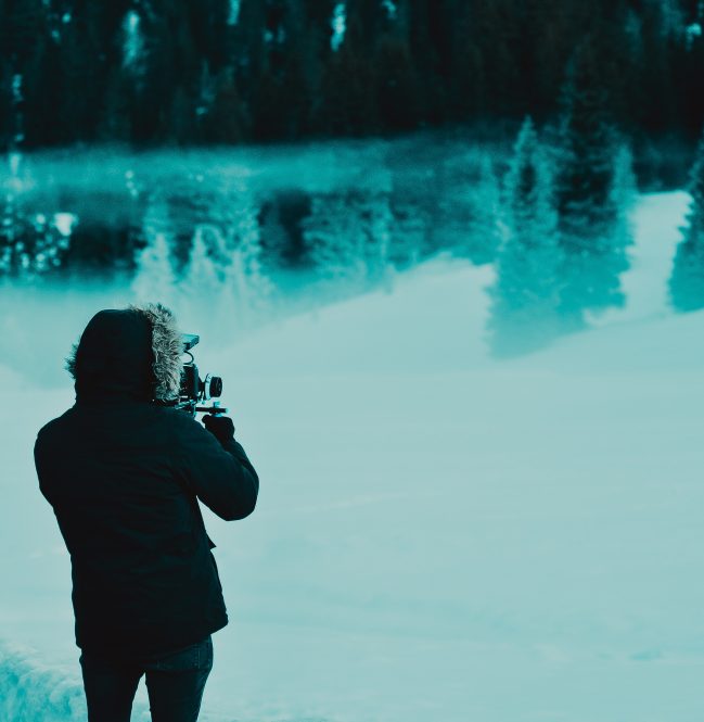 person filming a shot of the snowy scenery