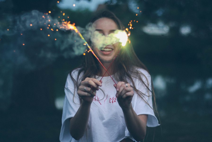 woman igniting sparkler sticks